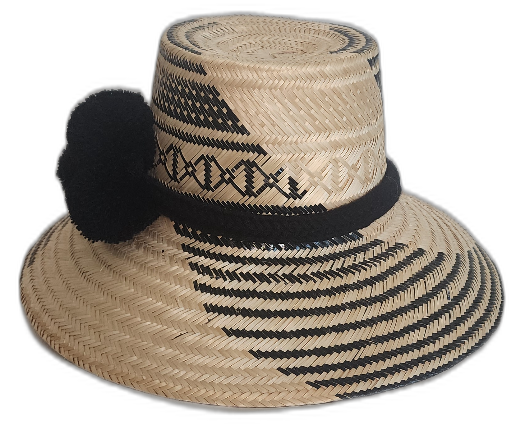 Minimalist boho chick hat woven from Iraca palm, featuring black-on-natural weaving and cultural black pompoms.