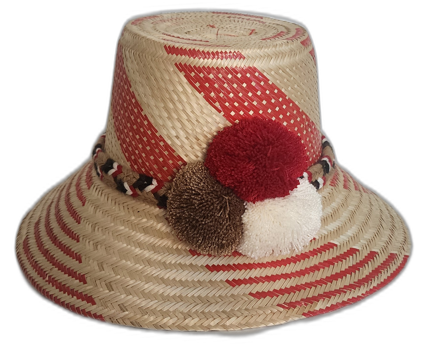 Handmade Wayuu straw hat featuring bold red patterns, with decorative white, brown, and red pompoms.