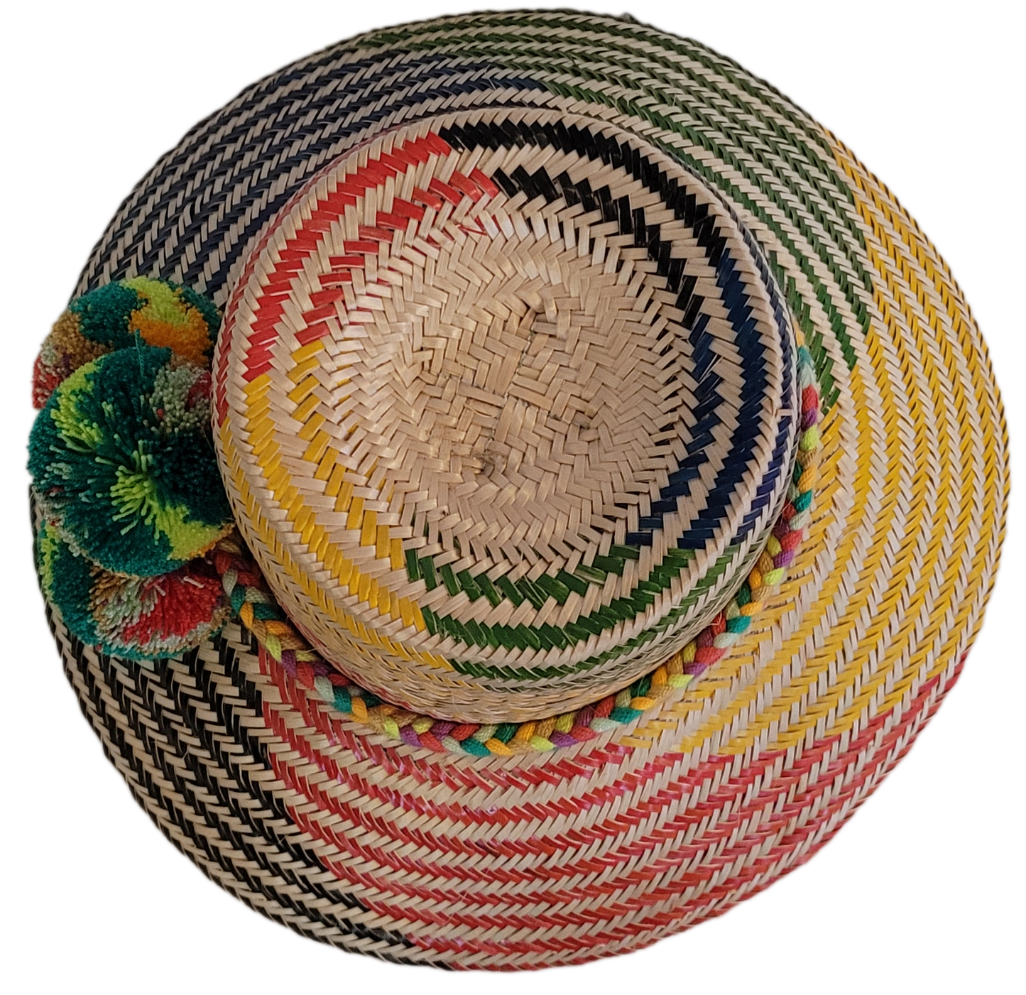 Colorful Wayuu straw hat handmade with striking woven patterns and green pompoms.