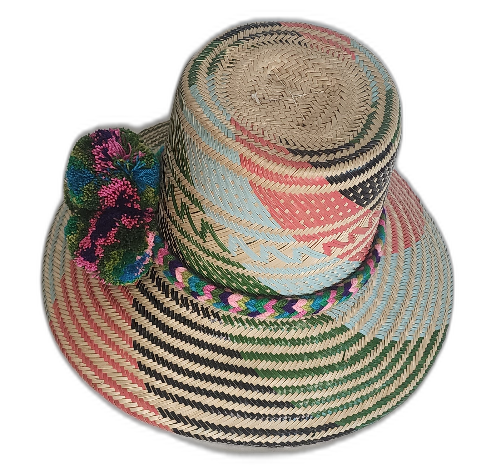 Artisan Wayuu hat crafted from Iraca palm with vibrant weaving and expressive pompom accents.