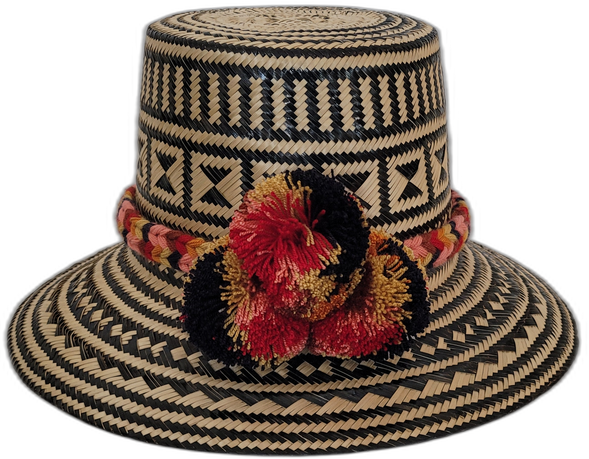 Handmade Wayuu straw hat with geometric patterns and red-black pompoms