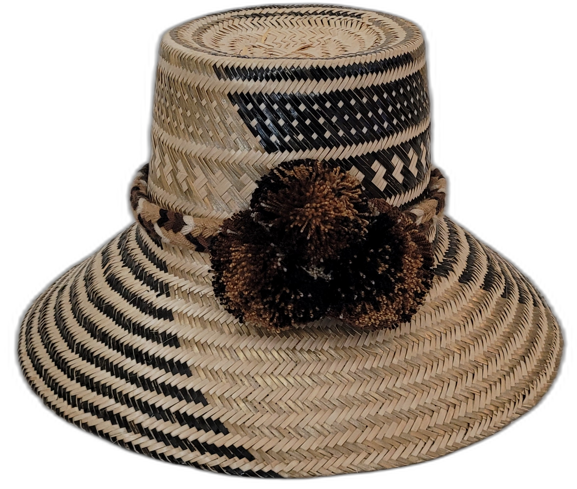 Zuri handmade Wayuu straw hat with black and brown weave and earth-toned pompoms