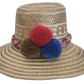 Handwoven Wayuu straw hat with colorful braided band and red, brown, and blue pom-poms — a boho, artisanal summer accessory.
