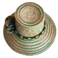 "Handmade colorful Wayuu hat woven from Iraca palm, adorned with culturally significant pompoms, adjustable fit."