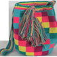 Image of a colorful, handmade crochet Wayuu bag featuring intricate bohemian patterns. This boho crossbody bag, created by indigenous Wayuu artisans from Colombia and Venezuela, showcases vibrant colors and geometric motifs inspired by the Guajira Peninsula. The bag varies in size and includes adjustable straps, making it both stylish and functional for everyday use or beach outings.