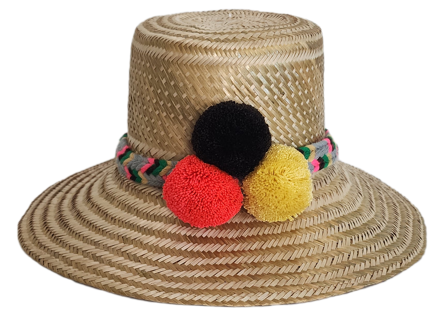 Boho Wayuu straw hat with natural weave, colorful braided band, and vibrant pom-poms in black, red, and yellow — a handcrafted, bohemian summer accessory full of artisan charm.