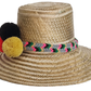 Boho Wayuu straw hat with natural weave, colorful braided band, and vibrant pom-poms in black, red, and yellow — a handcrafted, bohemian summer accessory full of artisan charm.