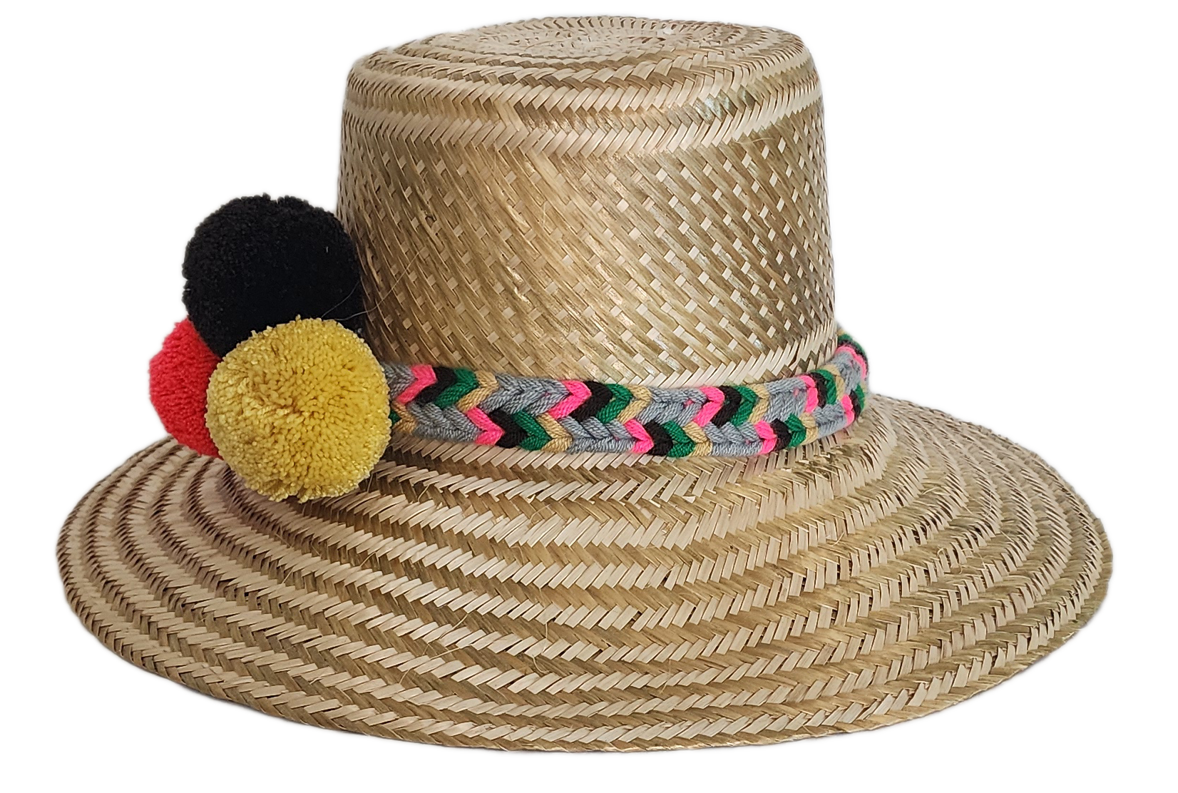 Boho Wayuu straw hat with natural weave, colorful braided band, and vibrant pom-poms in black, red, and yellow — a handcrafted, bohemian summer accessory full of artisan charm.