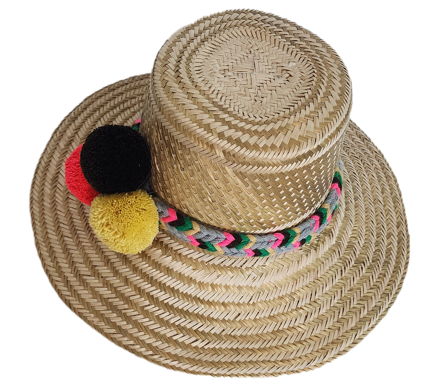 Boho Wayuu straw hat with natural weave, colorful braided band, and vibrant pom-poms in black, red, and yellow — a handcrafted, bohemian summer accessory full of artisan charm.