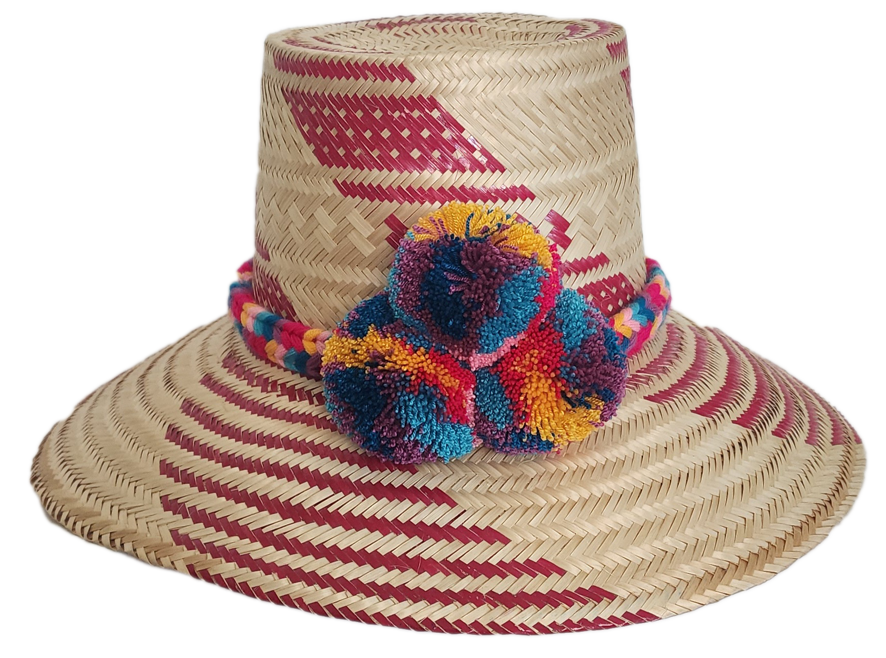 Handmade straw hat with red woven designs and a cheerful, fluffy pompom band in shades of blue, red, yellow, and purple, adding a colorful touch.