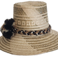 A stylish, handmade straw hat featuring intricate light and dark straw geometric patterns and a unique band with black, brown, and cream twisted elements and a black and brown pompom.
