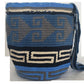 A vibrant and colorful crochet bag featuring boho-inspired Wayuu patterns. The bohemian-style accessory is intricately handcrafted with a multitude of bright, vivid colors, showcasing traditional Wayuu designs in a stylish, modern crochet technique.