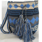 A vibrant, colorful crochet bag featuring a boho-inspired Wayuu design. The handmade piece showcases intricate patterns typical of Bohemian style, with a rich palette of bright, eye-catching colors. Ideal for adding a touch of artisanal charm to any outfit.