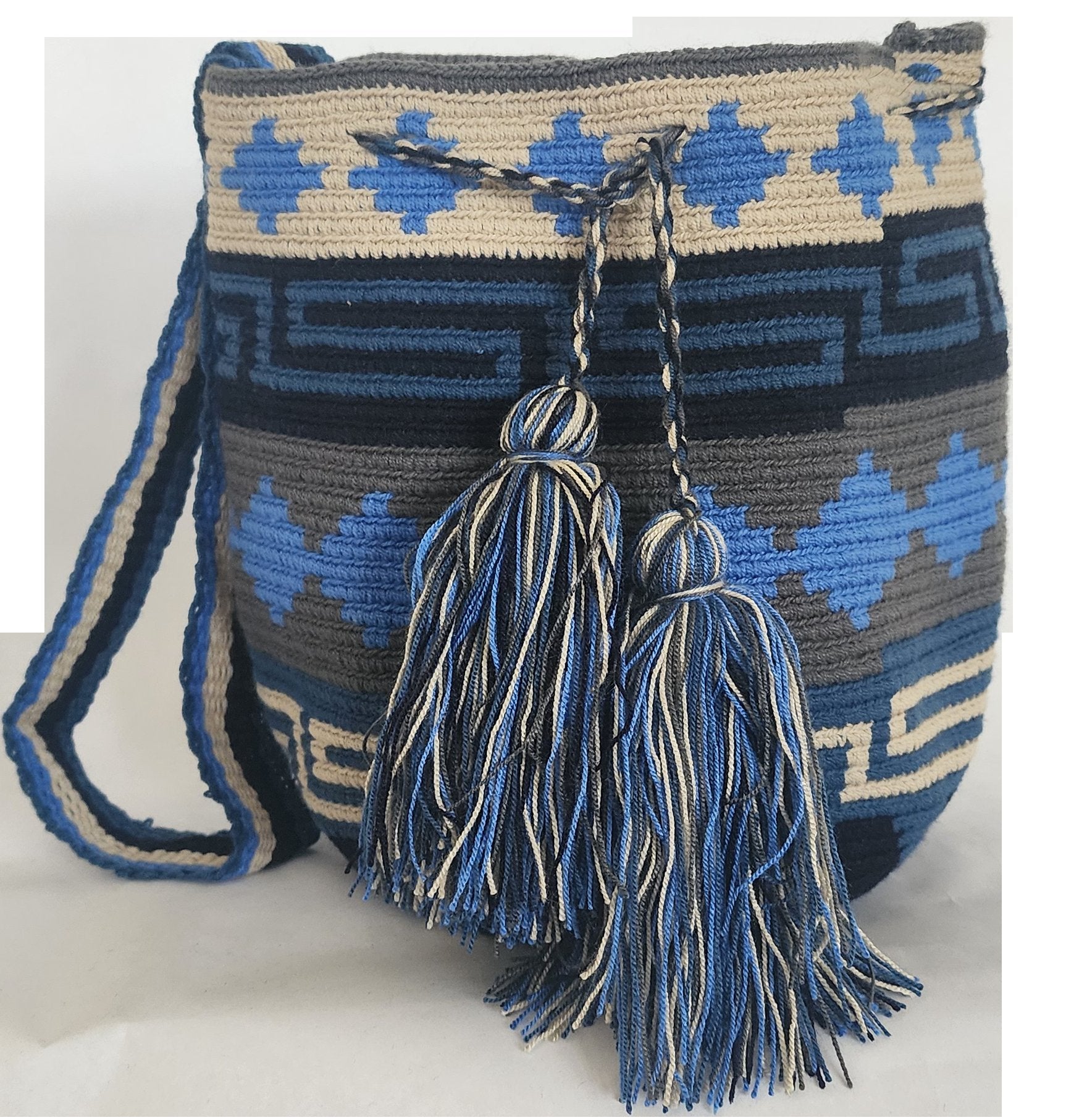 A vibrant, colorful crochet bag featuring a boho-inspired Wayuu design. The handmade piece showcases intricate patterns typical of Bohemian style, with a rich palette of bright, eye-catching colors. Ideal for adding a touch of artisanal charm to any outfit.