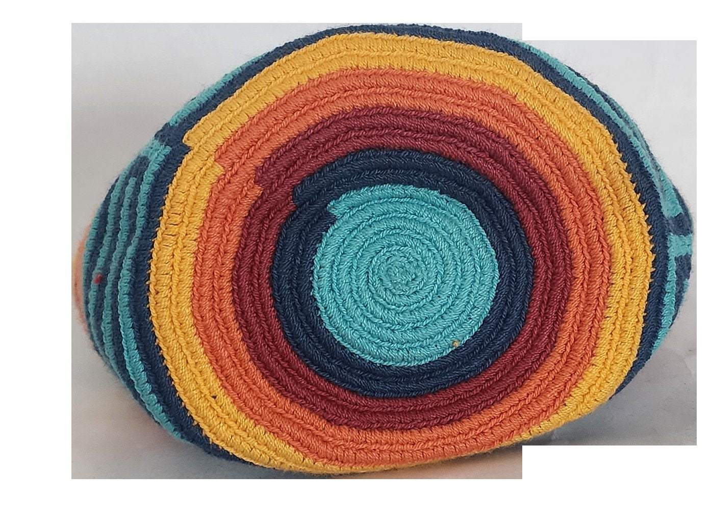 A vibrant, colorful crochet bag featuring a boho-Wayuu design. The item showcases intricate patterns typical of Bohemian and Wayuu style, with a rich mix of bright, eye-catching colors. Handmade, the bag exemplifies skilled crochet craftsmanship, ideal for adding a bohemian flair to any outfit.