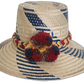 Handmade Wayuu straw hat with blue diagonal designs and vibrant pompoms