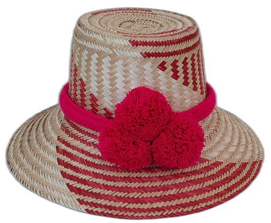 Adelyn handmade Wayuu straw hat with red and natural palm weave and large red pompoms

