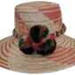 Handmade Wayuu straw hat with red, brown, and green pompoms.Bohemian Wayuu hat featuring soft tones and textured pompoms

