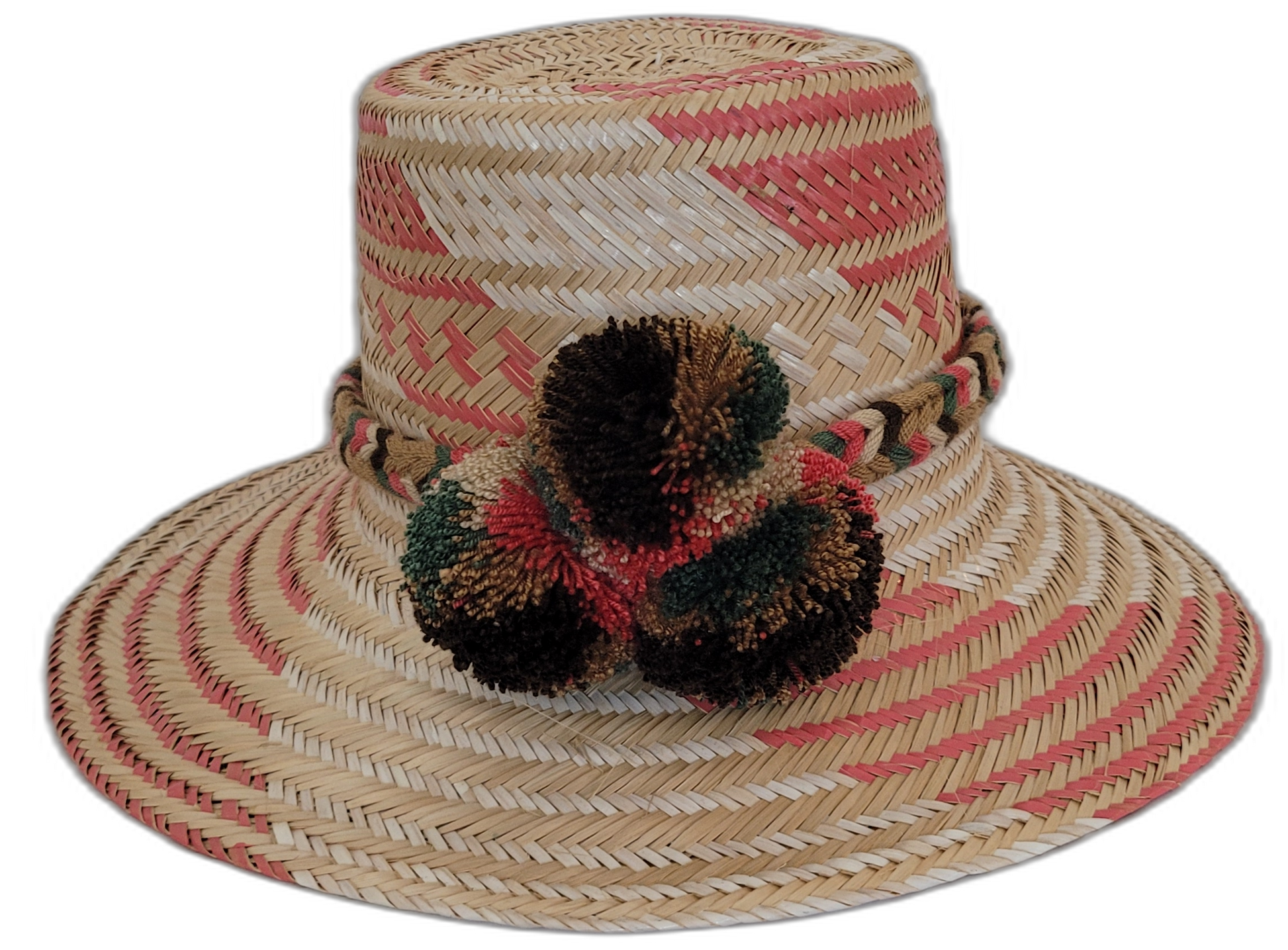 Handmade Wayuu straw hat with red, brown, and green pompoms.Bohemian Wayuu hat featuring soft tones and textured pompoms

