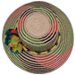 Alani boho straw hat featuring green, red, and black palm weave with bold pompoms

