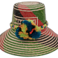 Alani handmade Wayuu straw hat with green, red, black weave and rainbow pompoms

