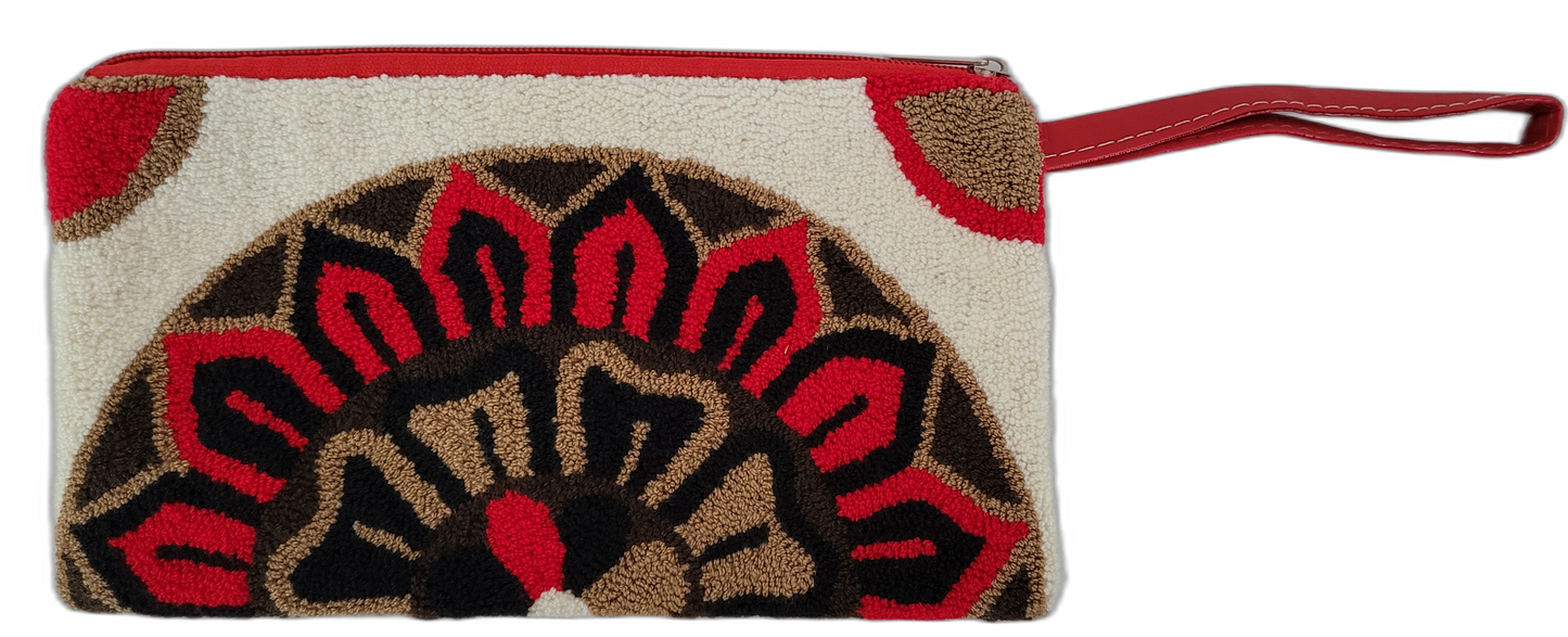 Boho wristlet clutch with bold artisan design and red leather strap

