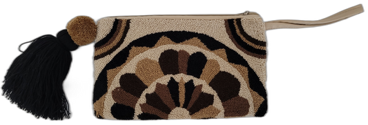 Bohemian crochet Wayuu clutch in earthy tones with black tassel and tan handle

