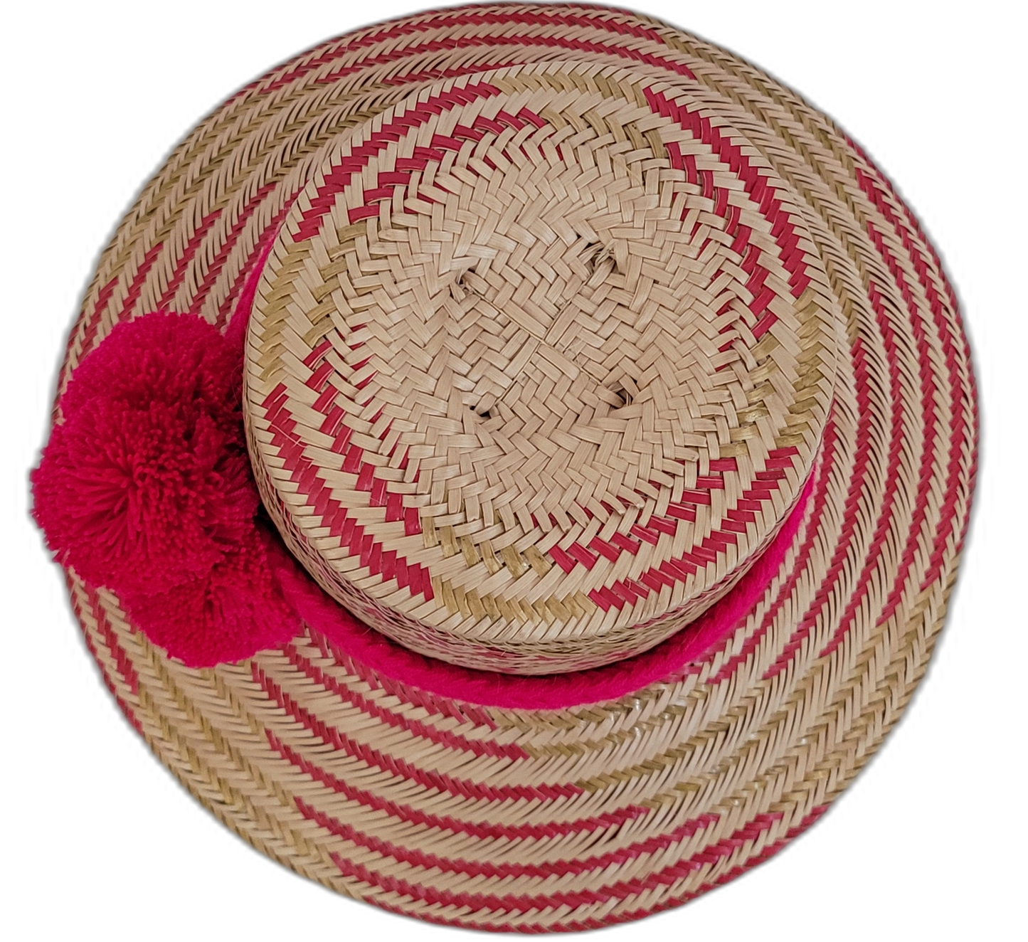 Artisan Wayuu straw hat with bright red pompoms, perfect for summer.

