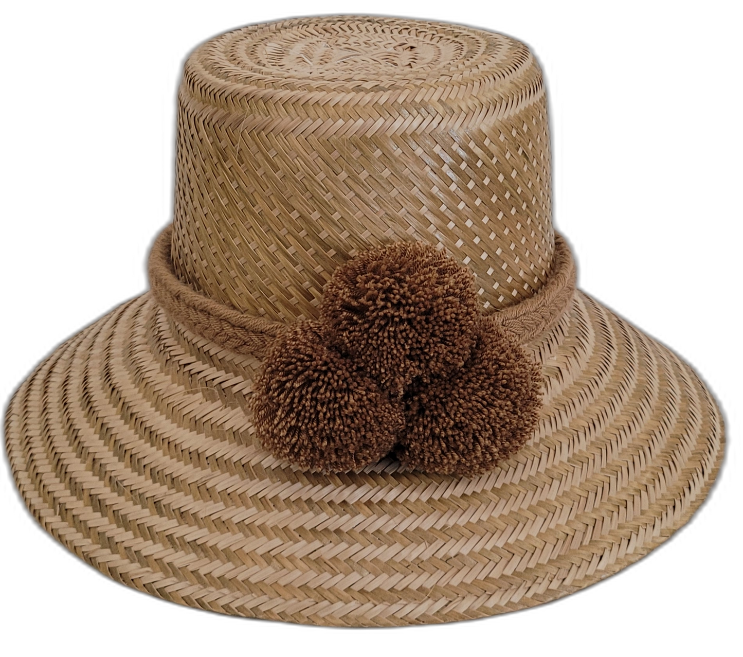 Solid natural Wayuu straw hat handmade with brown pompoms.

