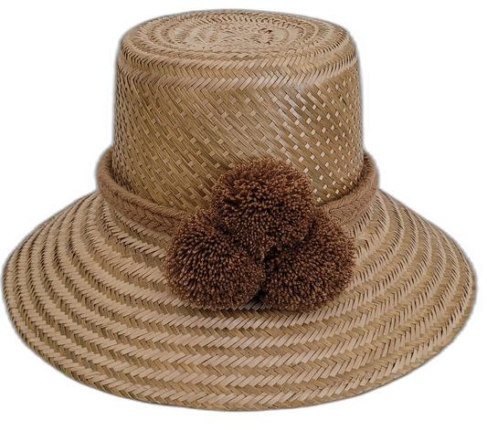 Solid natural Wayuu straw hat handmade with brown pompoms.


