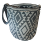 Artisan-made crochet Wayuu bag in soft gray and ivory tones with a bohemian diamond motif and handmade braided strap.