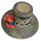 Colorful handcrafted Wayuu straw hat with bright orange and blue pompoms.