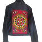"Artisan-made denim jacket with colorful punch needle embroidery on the back, showcasing unique, vibrant designs."