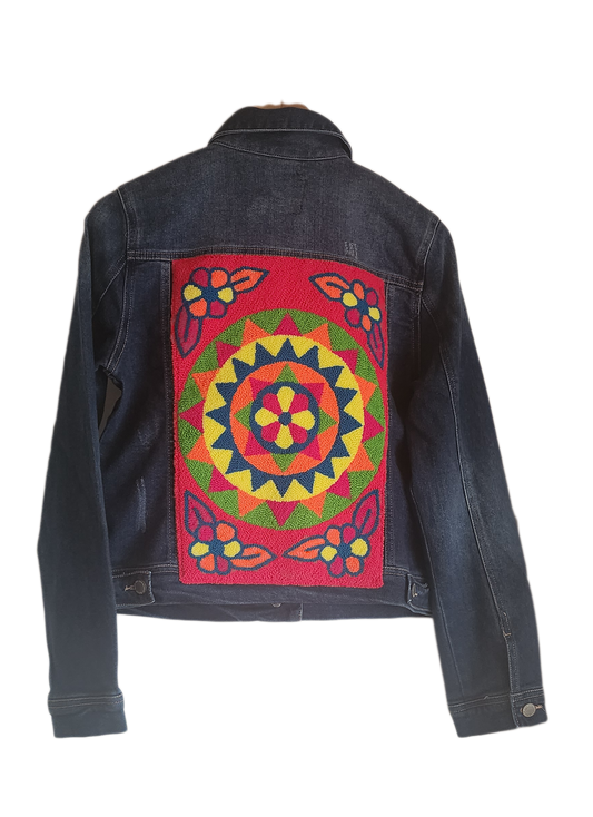 "Artisan-made denim jacket with colorful punch needle embroidery on the back, showcasing unique, vibrant designs."