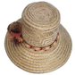 Natural palm straw hat featuring red, brown, and gold pompoms