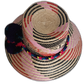 Colorful handmade boho hat with a pompom cluster and vibrant band
