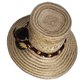 Artisan Wayuu hat featuring woven band and burgundy-green pompoms

Cultural Wayuu straw hat with dark pompom accents and geometric design