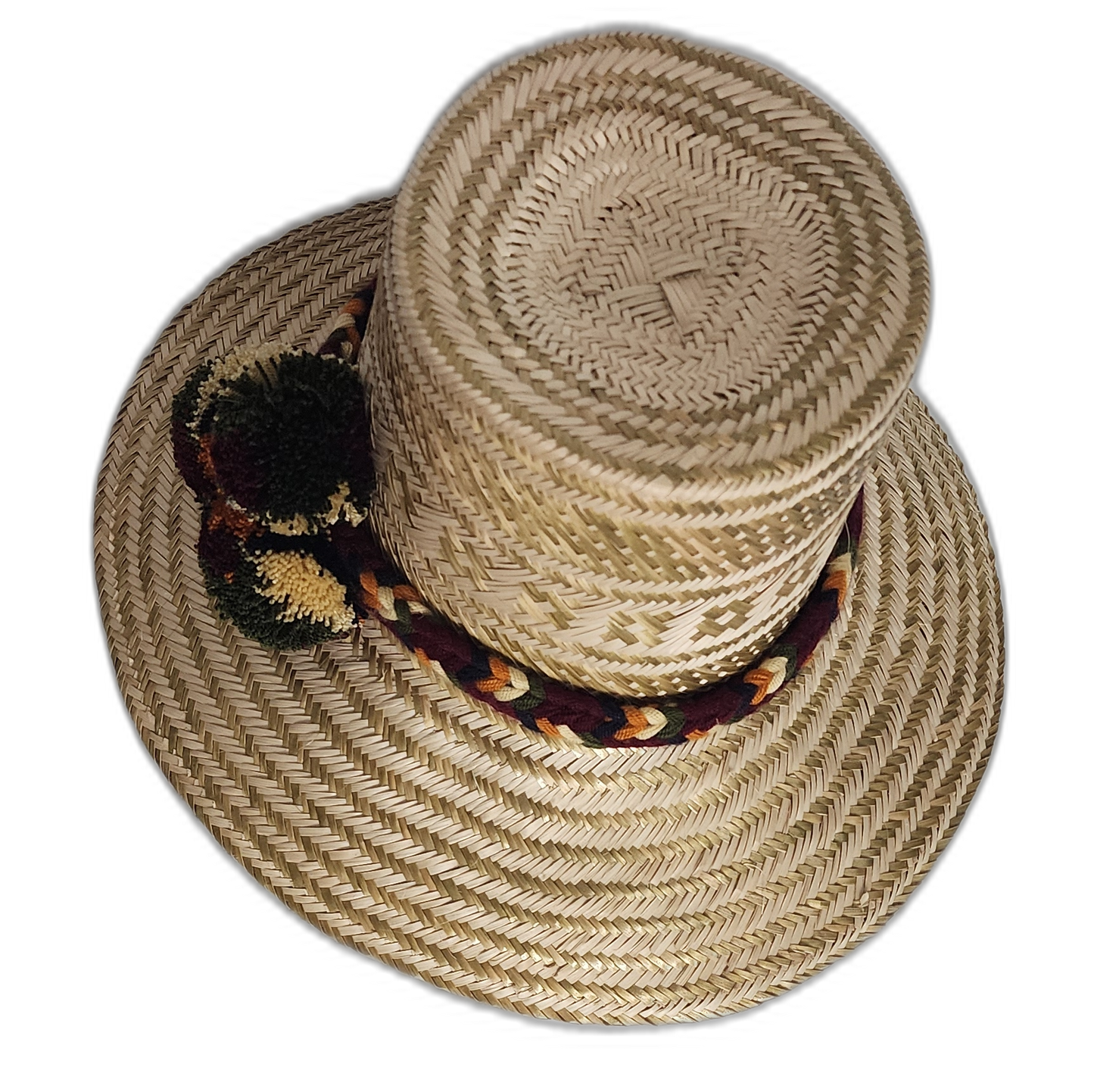 Artisan Wayuu hat featuring woven band and burgundy-green pompoms

Cultural Wayuu straw hat with dark pompom accents and geometric design