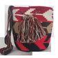Boho Wayuu crochet bag in red and neutral tones, featuring geometric designs and a colorful tassel tie — handcrafted for the modern bohemian.
