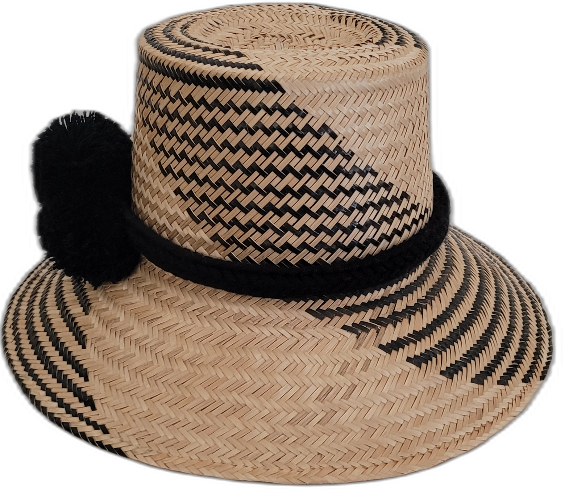 Artisan Wayuu hat, black woven patterns on natural straw, black pompom accent.

