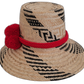 Artisan Wayuu black-and-natural straw hat with bold red pompom details.

