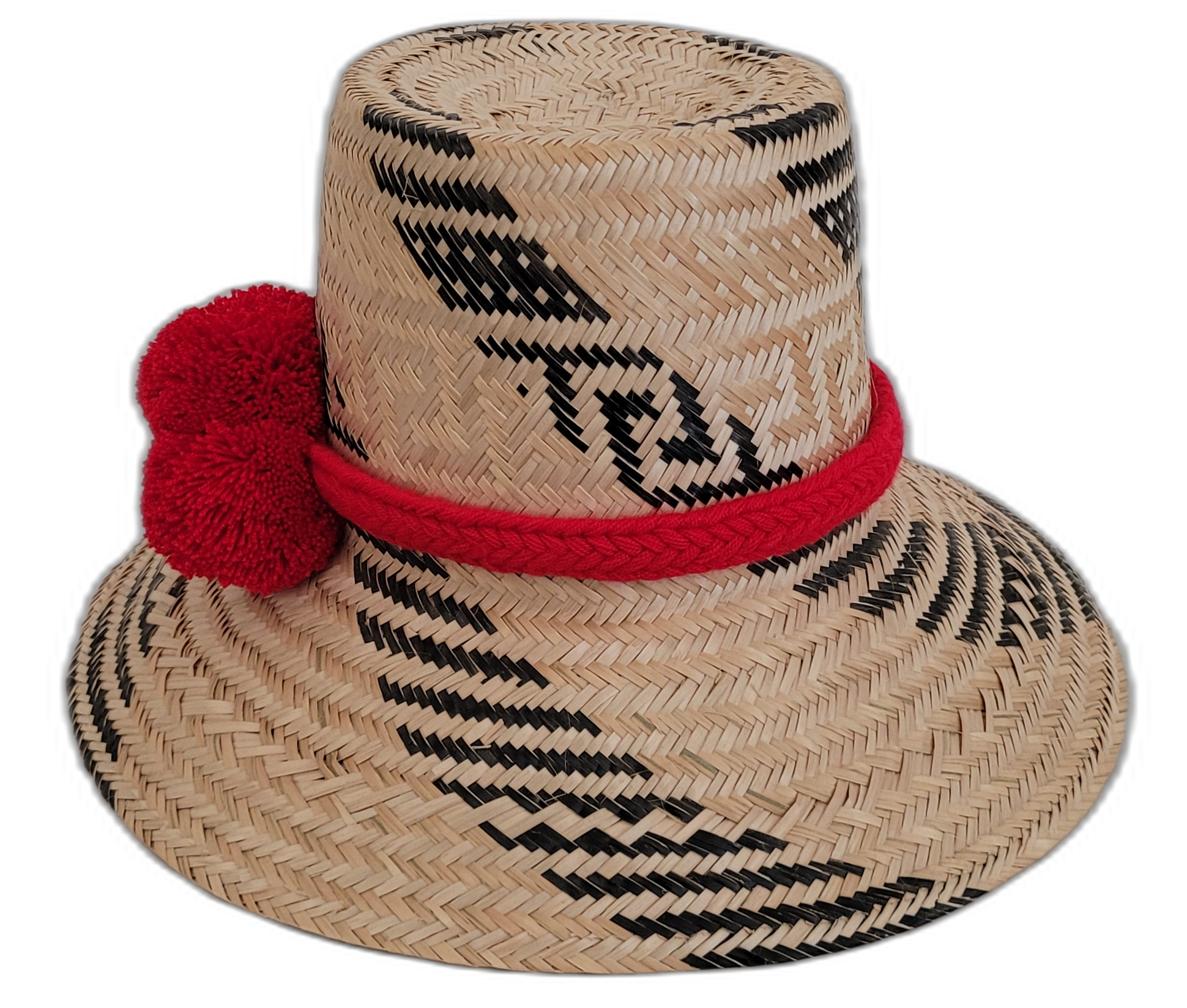 Artisan Wayuu black-and-natural straw hat with bold red pompom details.


