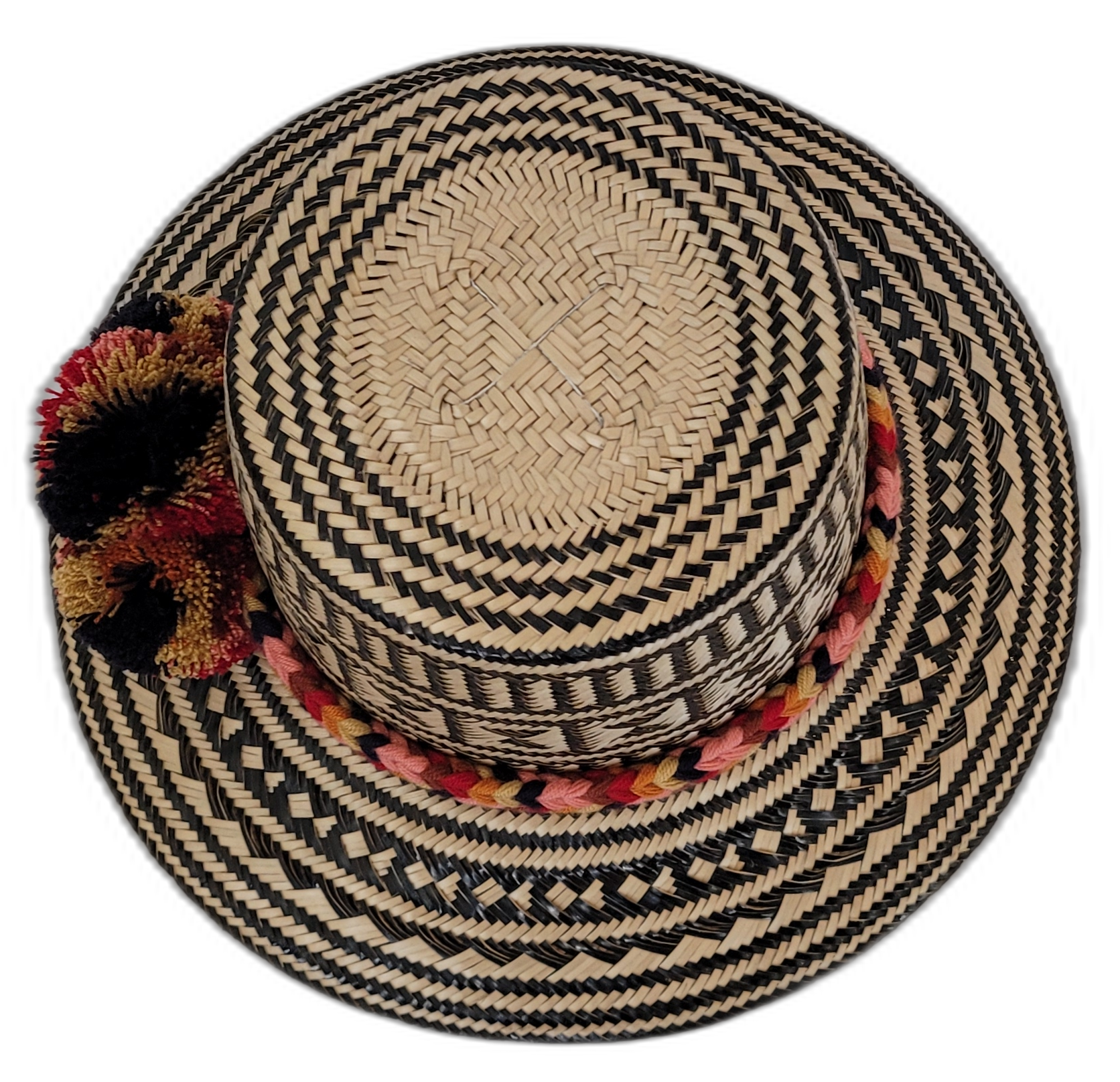 Bohemian straw hat featuring red, gold, and black pompoms and tribal design