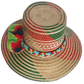 Artisan straw hat with bold red and green tones, neon pompoms, and palm fiber weave