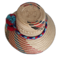 Colorful bohemian straw hat with bold geometric design and handmade pompoms