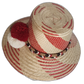 Artisan straw hat with vibrant red designs, handwoven by Wayuu women and finished with traditional pompoms.