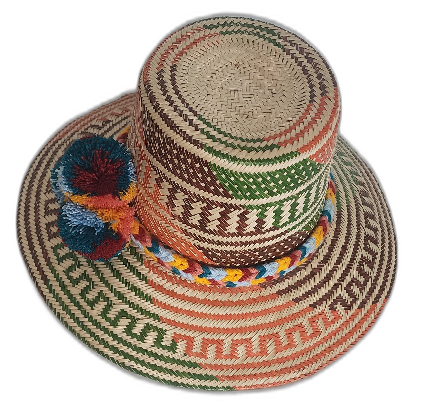 Wayuu artisan hat featuring woven rust and green patterns with bright pompom accents