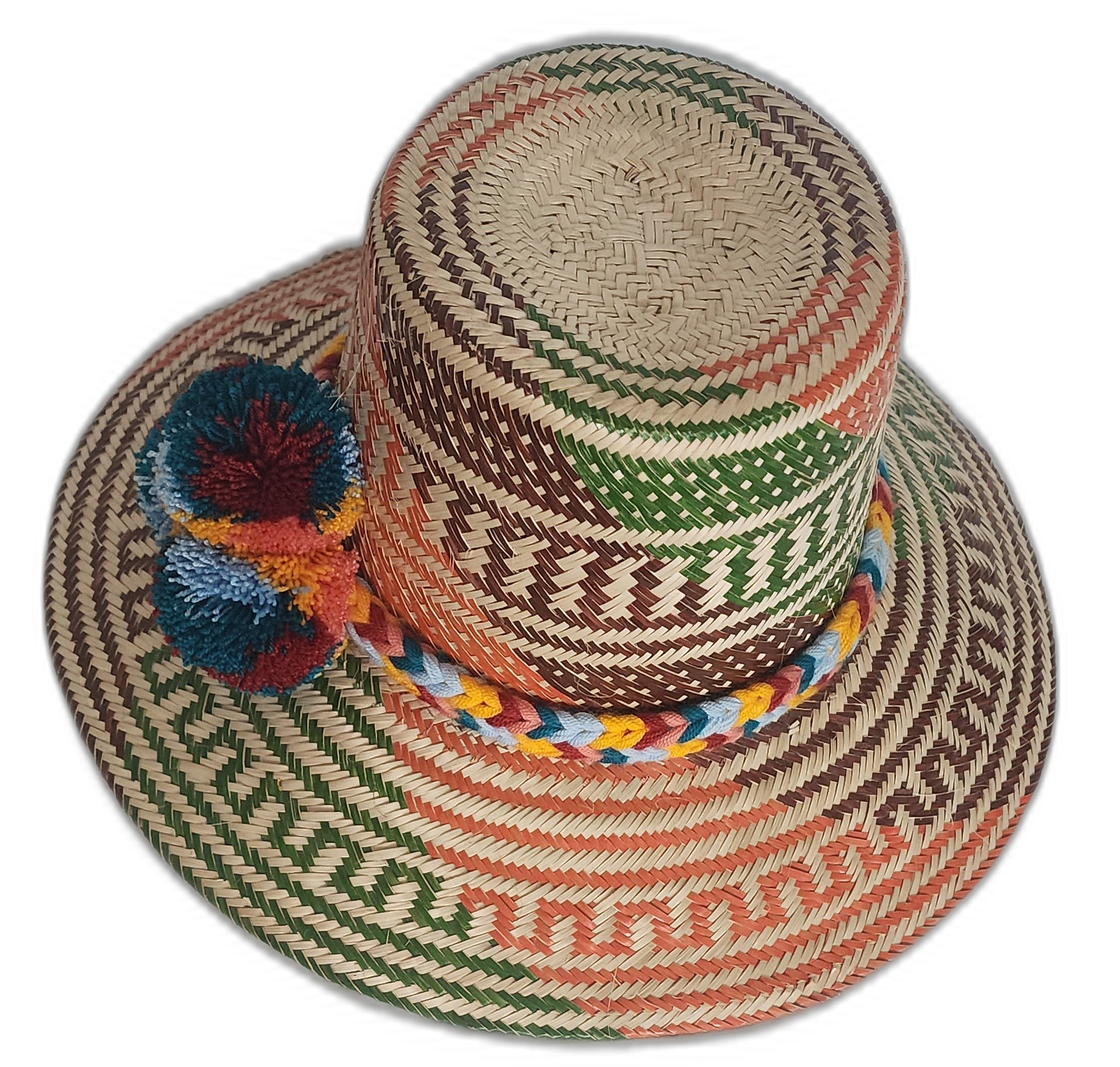 Wayuu artisan hat featuring woven rust and green patterns with bright pompom accents