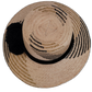 Artisan-crafted Wayuu hat in natural straw with bold black pompoms.

