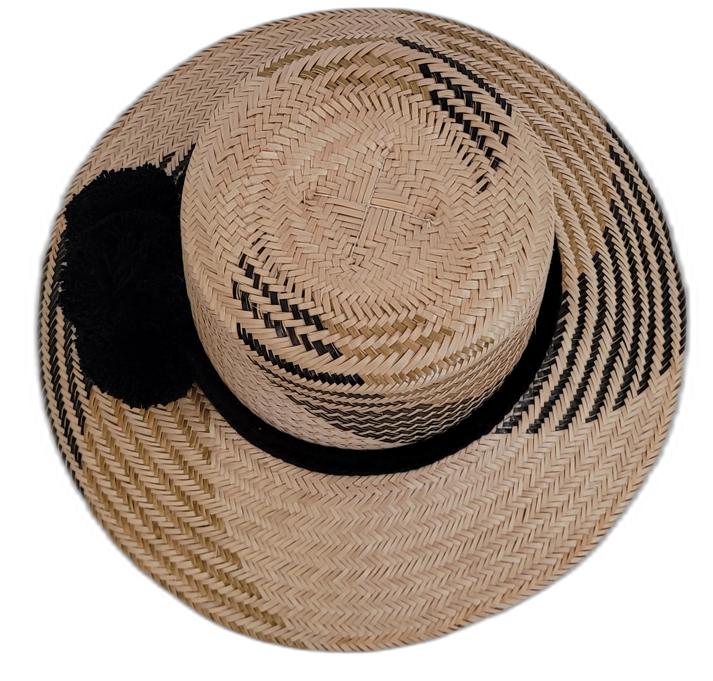 Artisan-crafted Wayuu hat in natural straw with bold black pompoms.


